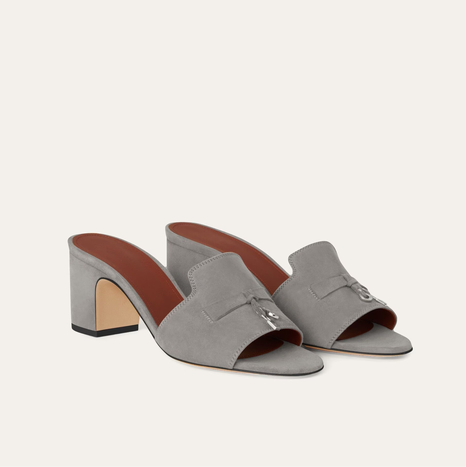 Gray high-heeled mules with brown insole on a white background